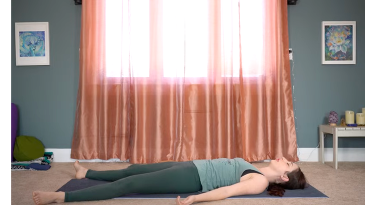 Yoga teacher lying on a mat