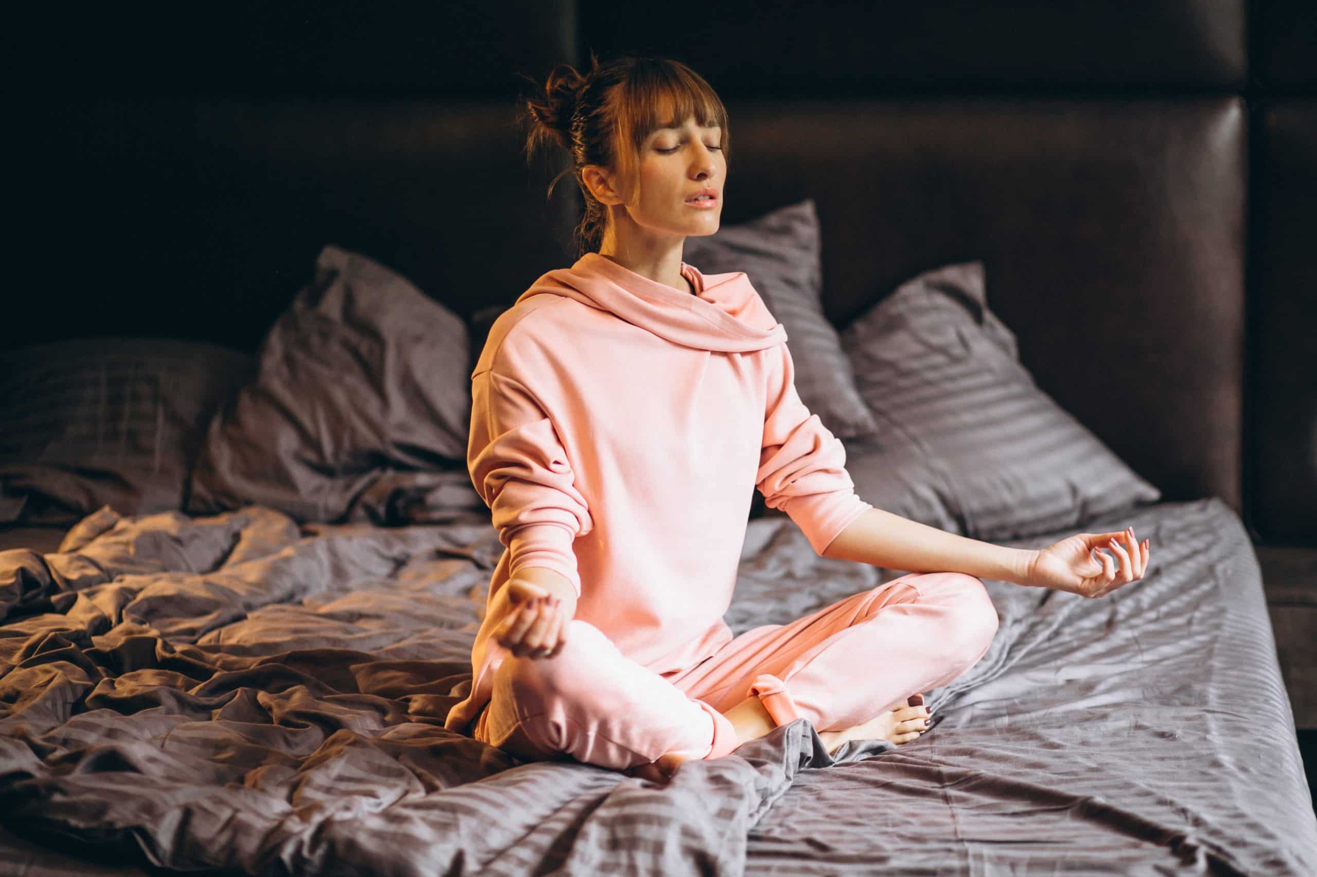 Woman doing yoga in bed morning affirmations, How to Teach Meditation for Restorative Sleep and Deep Rest