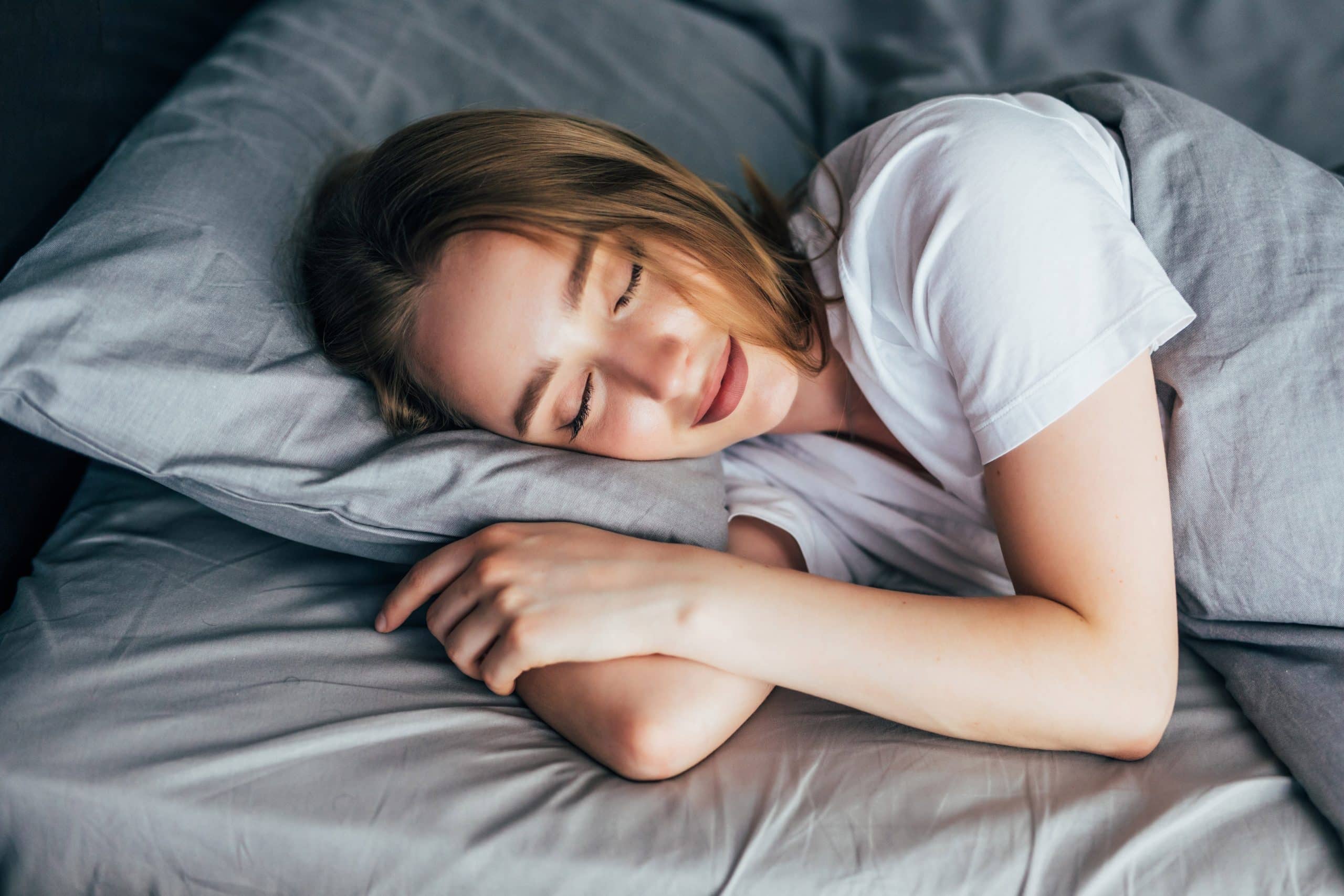 Beautiful young smiling woman sleeping in bed morning affirmations, How to Teach Meditation for Restorative Sleep and Deep Rest