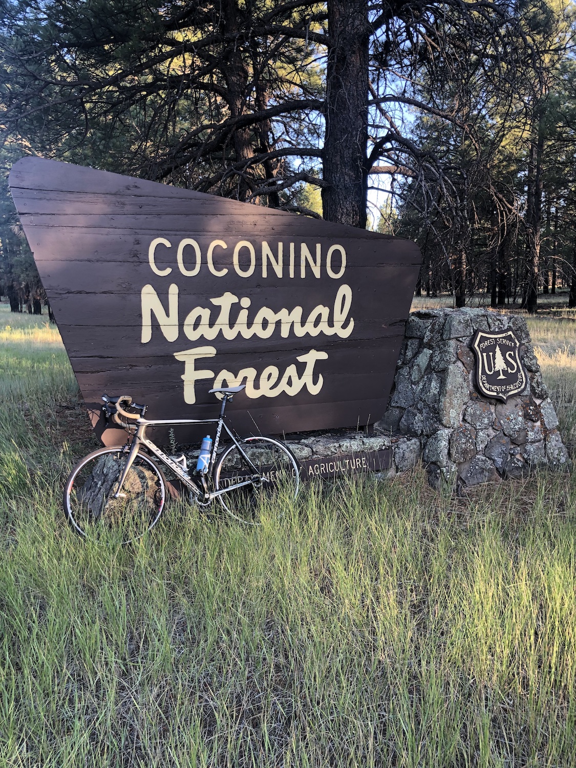 A bike leaning against a national park sign