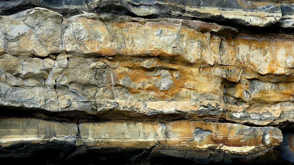 Detail of eroding cliff face showing alternating bands of Jurassic limestone and mudstone at Dunraven Bay on the Glamorgan Heritage Coast.