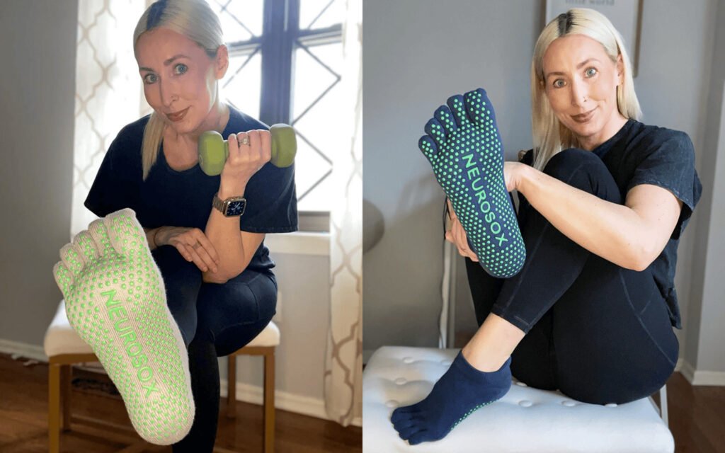 Yoga Grip Socks Guide: Non-Slip Performance & Toe Separation yoga grip socks 4 A side-by-side collage features the same individual indoors showcasing NEUROSOX yoga grip socks. In the left image, the person sits on a chair holding a green dumbbell, with one leg extended to display the sock’s sole—green and white grip dots and the 'NEUROSOX' branding are clearly visible. In the right image, the individual sits cross-legged on a white cushioned bench, holding one of the socks to highlight its design. Both scenes are softly lit with wooden floors and white curtains in the background. The image emphasizes non-slip performance, toe separation, and lifestyle versatility of yoga grip socks.