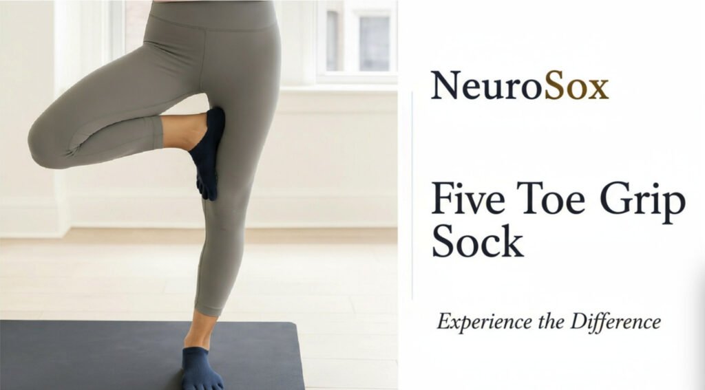Yoga Grip Socks Guide: Non-Slip Performance & Toe Separation yoga grip socks 5 A person stands on one leg in a yoga pose on a black mat, wearing grey leggings and navy blue five-toe grip socks. The socks feature individual toe compartments and a textured sole designed for non-slip performance. The room is softly lit with light-colored flooring and walls, creating a clean and focused environment. On the right side of the image, promotional text reads 'NeuroSox Five Toe Grip Sock' with the tagline 'Experience the Difference.' The image highlights the stability, balance, and enhanced traction provided by grip socks during yoga practice.