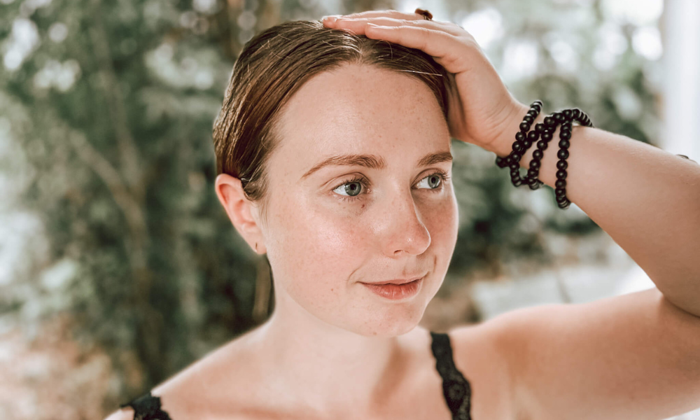 Final step in EFT tapping, shown tapping the top of the head to integrate emotional healing and promote full-body relaxation. Connects to the governing vessel.