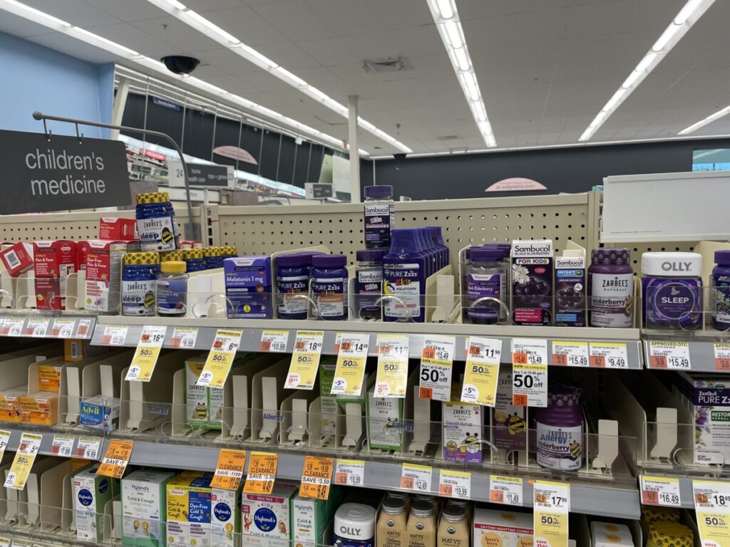 Photo taken in my local drug store. Most of the top row of consist of melatonin preparations for children.  For whatever reason melatonin products are usually branded in purple.