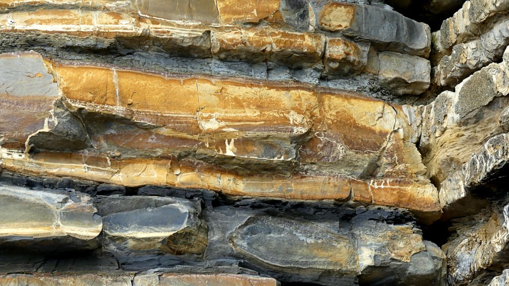 Detail of eroding cliff face showing alternating bands of Jurassic limestone and mudstone at Dunraven Bay on the Glamorgan Heritage Coast.