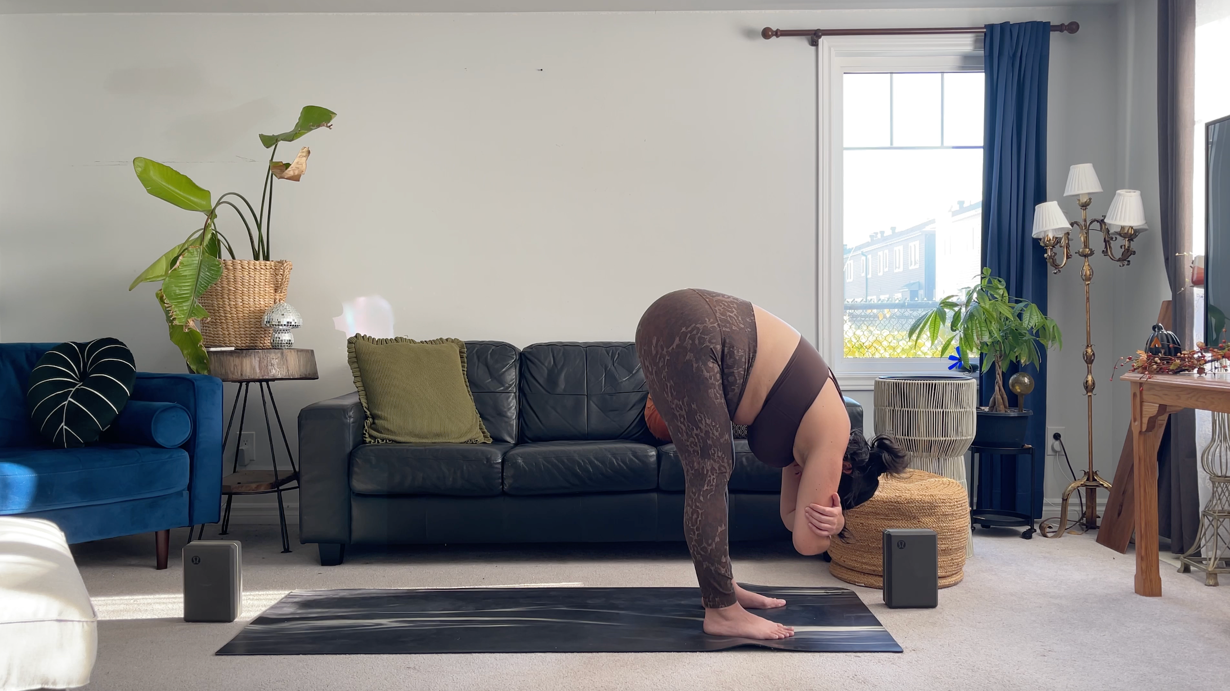Yoga teacher Taylor Lorenz in Standing Forward Bend, part of her full moon yoga routine
