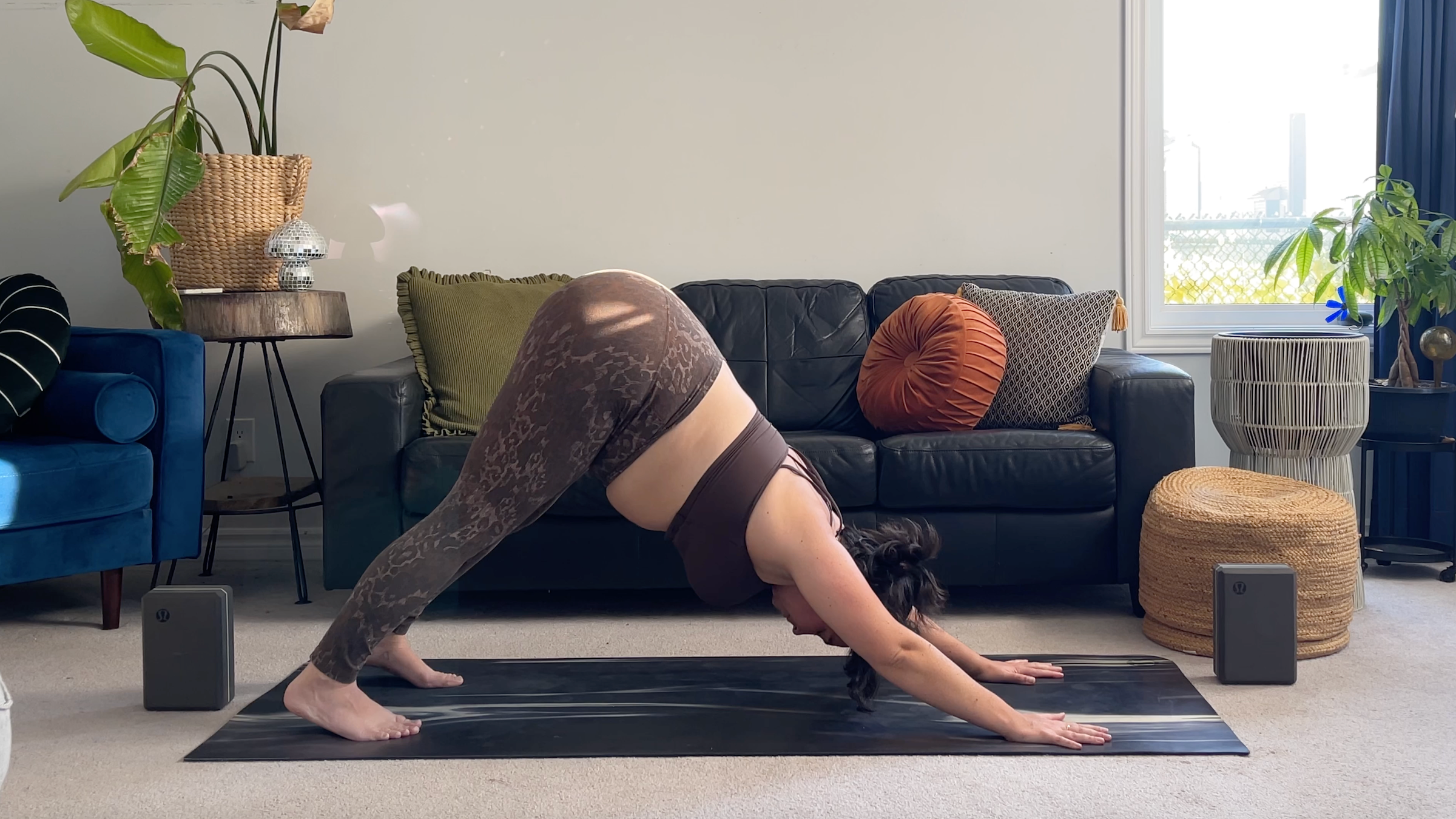 Yoga teacher Taylor Lorenz in Downward-Facing Dog, part of her full moon yoga flow