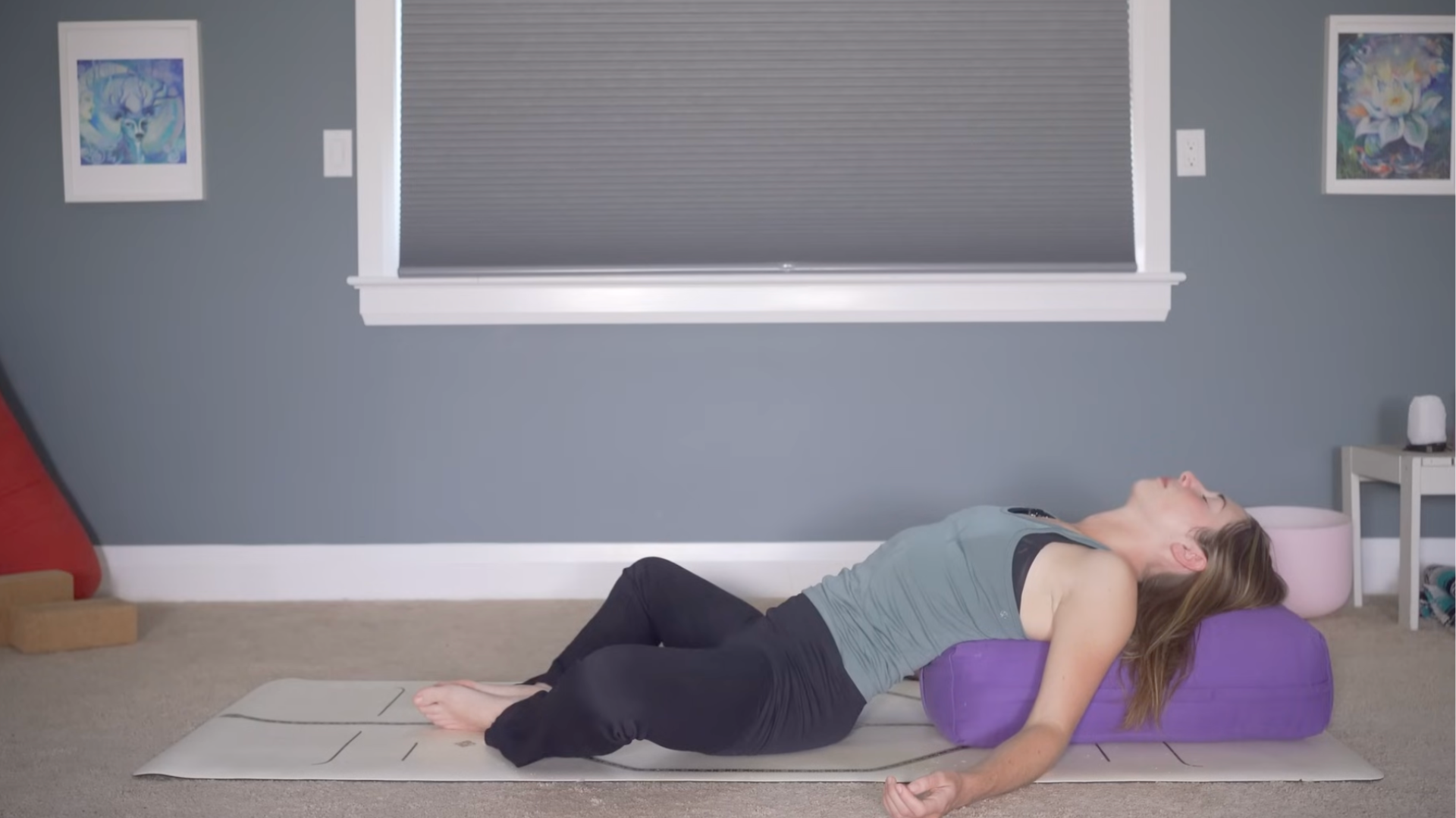Woman lying on a bolster during bedtime yoga